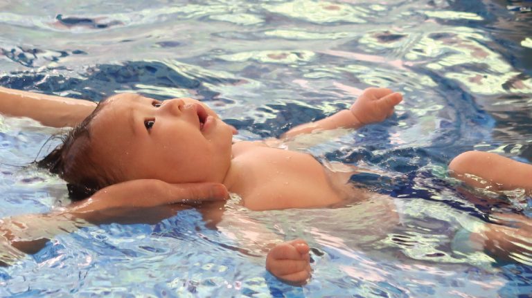 0-8個月新生兒在支撐下進行仰漂 (Back Float)，此階段課程著重於放鬆與感覺統合 (Sensory Integration)，喚醒寶寶與生俱來的親水本能。