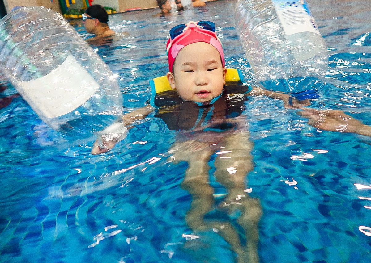 幼兒穿著救生衣並利用寶特瓶進行水上自救 (Water Safety) 演練，學習利用隨身物品增加浮力並保持仰漂求生姿勢。